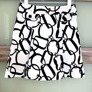 Trina Turk mini  pleat skirt with faux pockets ,side zip. Chain print